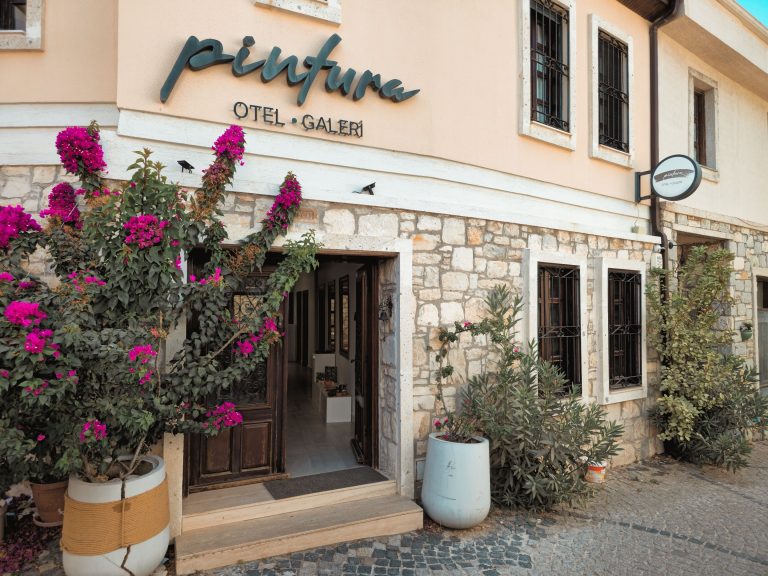 Quaint boutique hotel exterior adorned with vibrant flowers, showing the distinctive visual character a direct-booking banner can highlight.